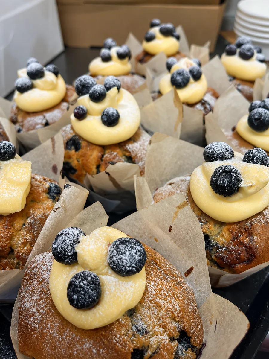 Blueberry-topped pastries in the cafe cabinet